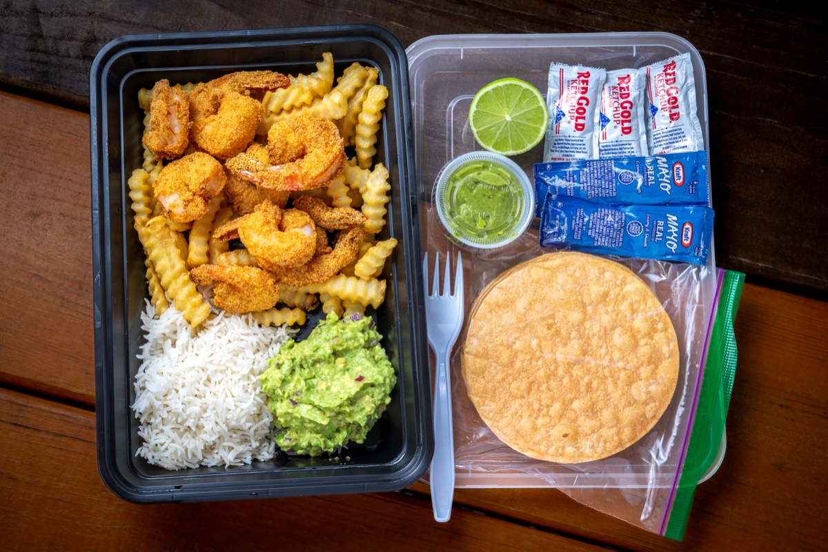 Mariscos El Jaguar breaded shrimp combo with crinkle fries, rice and guacamole — overhead