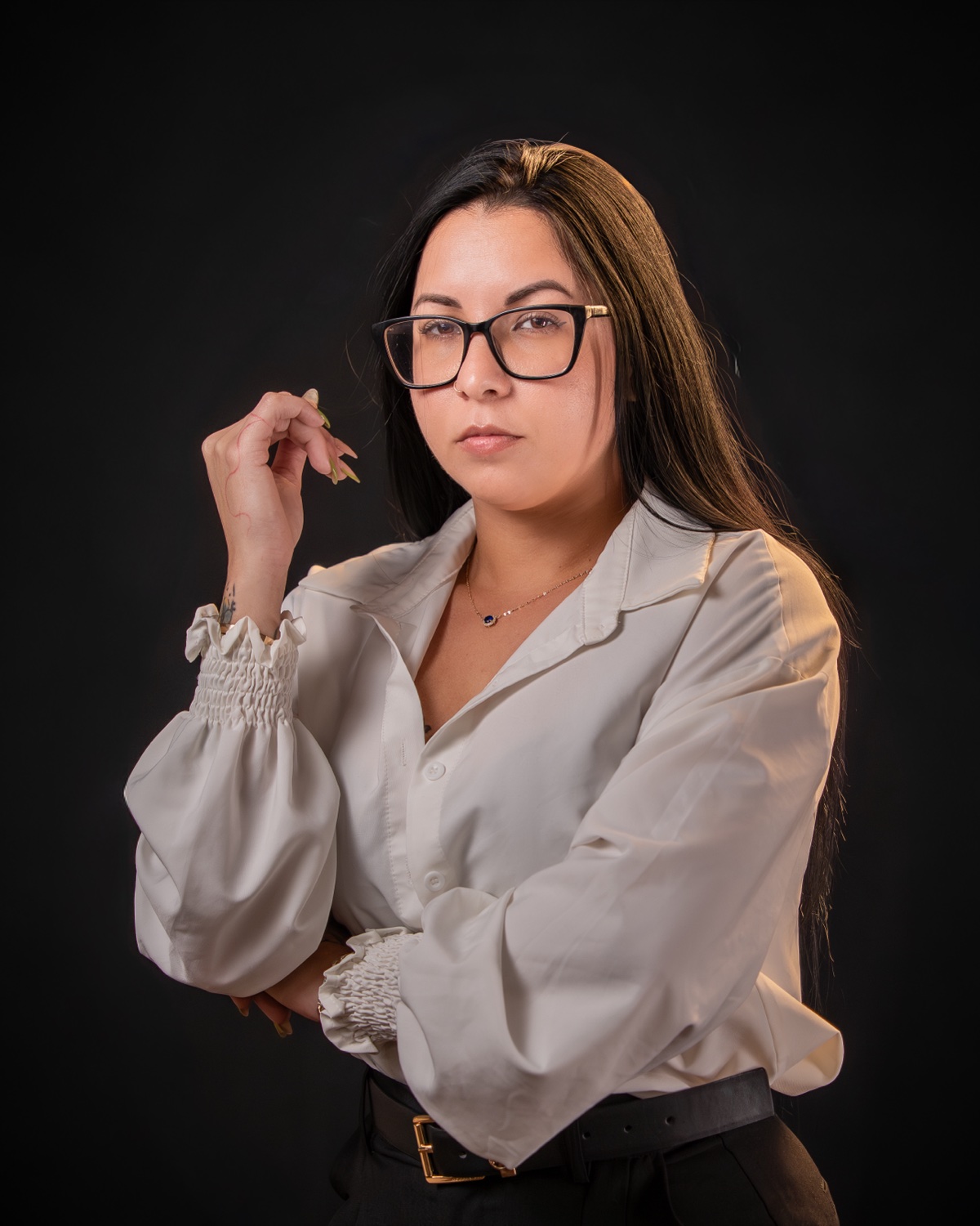 Business headshot in cream silk blouse, glasses, black backdrop — Austin business headshot photographer